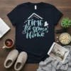Time to Stay Home quote in light blue script on a navy t-shirt, featuring a white house outline and heart