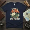 Goose tending campfire with "Time to Stir the Pot" text, vintage outdoor illustration style, navy blue t-shirt