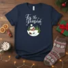 Tis the season Christmas T-Shirt with a circular winter scene of a house, trees, and sleigh with reindeer
