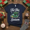Tis The Season Christmas Tree Car T-Shirt design with white text and a green retro car carrying a Christmas tree