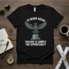 Black t-shirt with 'TO BEGIN AGAIN FAILURE IS SIMPLY THE OPPORTUNITY' text and a stylized phoenix graphic rising from ruins