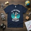 To The Moon Buy More T-Shirt with rocket launching from the moon, dark blue graphic tee design