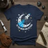 Navy blue t-shirt with "To The Moon And Beyond" text, a rocket ship, moon, and stars graphic design