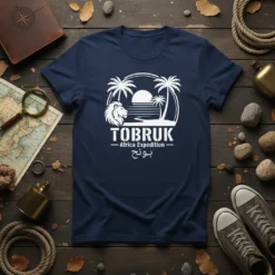 Tobruk Africa Expedition بونج text with lion, palm trees, and sunset graphic on a navy t-shirt