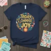 Navy t-shirt with "Today I Choose JOY" in a circular floral design, featuring a smiling sun and peace signs