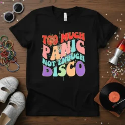 Retro graphic t-shirt with "Too Much Panic Not Enough Disco" text in colorful, wavy fonts and a disco ball graphic