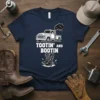Navy blue t-shirt with "Tootin' And Bootin'" text, vintage pickup truck graphic, and cowboy boots design
