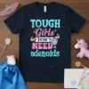 T-Shirt with "TOUGH Girls DON'T NEED adenoids" text, featuring a shield and flexed arm graphics