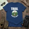 Trail Adventure Awaits t-shirt design with a runner on a mountain path and green trees, featuring white text TRAIL and