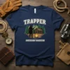 Trapper American Tradition t-shirt featuring a silhouette of a trapper with a rifle by a cabin and campfire