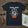 T-shirt with "TRAVEL MODE: ON" text, a vintage camera, passport, and compass graphic