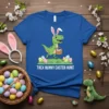 Trex Bunny Easter Hunt t-shirt featuring a green cartoon T-Rex wearing bunny ears and carrying an Easter basket full of