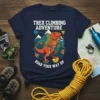 Trex Climbing Adventure ROAR YOUR WAY UP t-shirt featuring an orange T-Rex climbing with chalk bag and mountains in the