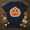 Navy t-shirt with a smiling jack-o'-lantern design and the words "Trick or Treat" in distressed text on a small wooden