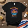 Tropical Bliss Paradise text with palm trees, ocean, and sunset graphic on a black t-shirt