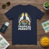 TROPICAL PARROTS text with two cockatoo parrots on either side of a fruit bowl, white text on navy shirt