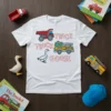 White t-shirt with "Truck Truck Goose" text and graphics of a red dump truck, yellow fire truck, and a white
