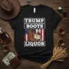 Trump Boots Liquor T-Shirt with American flag, cowboy boots, and whiskey bottle graphic. Text reads "TRUMP BOOTS LIQUOR" and "AMERICAN