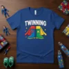 T-shirt with the word TWINNING above two superhero boots, one blue with a lightning bolt and one green with a