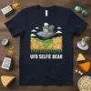 UFO Selfie Bear T-Shirt featuring a squirrel in a chef hat and sunglasses on a UFO hovering over cheese blocks