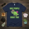 Ugly People Cheat Too! text with a cool chameleon playing poker graphic on a navy t-shirt