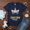 Navy t-shirt featuring the text UNICORN Magic in gold glitter, with a crystal unicorn horn and eyes graphic