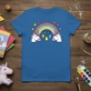 Blue t-shirt featuring a cartoon unicorn rainbow design with colorful raindrops and stars