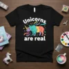 Black t-shirt with "Unicorns are real" text above a colorful rhino unicorn graphic with stars and swirls