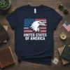 UNITED STATES OF AMERICA text with an eagle head graphic superimposed on an American flag design on a navy t-shirt