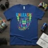 UNLEASH! text above a colorful, roaring lion graphic with lightning bolts and geometric shapes on a navy blue t-shirt