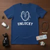 Unlucky T-Shirt with a broken mirror graphic and white text, symbolizing bad luck and superstition