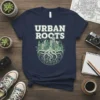 Urban Roots T-Shirt featuring a graphic of a cityscape growing from tree roots, with text "URBAN ROOTS" above