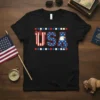 Black t-shirt with "USA" text in red, white, and blue, featuring an American eagle and flag-inspired design elements