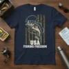 USA Fishing Freedom t-shirt featuring a bass fish against a camouflage American flag background, text "USA FISHING FREEDOM"