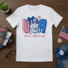 White t-shirt with "USA (but in a liberal way)" text design, featuring patriotic colors and political commentary graphics