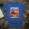 Utah Mountain River Landscape t-shirt with bold white "UTAH" text above a colorful graphic of mountains, river, and desert scene