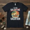 V is for Vacation Not Valentine text with beach and luggage graphic on a dark t-shirt
