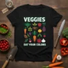 Veggies Eat Your Colors T-Shirt featuring a collage of colorful vegetable icons and text, black t-shirt design