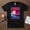 Vibes Tropical Night t-shirt design featuring a large wave, palm trees, and a sunset graphic
