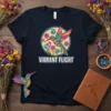 Vibrant Flight text with a colorful, stylized hummingbird design inside a circular frame, on a navy t-shirt