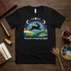 Vincent's Hopping Night t-shirt design with a black rabbit jumping under a moon and stars sky, surrounded by wheat and