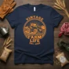 Vintage Farm Life Est. 1920 text with a vintage tractor graphic on a navy blue t-shirt
