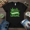 Black t-shirt with green text "VIRGINIA LEGAL" and a green ribbon, overlaying a stylized map of Virginia filled with cannabis