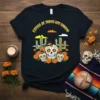 Vispera de Todos los Santos T-Shirt with sugar skulls, marigolds, and cacti design