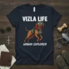 Vizsla dog wearing goggles and a vest with "Vizsla Life Urban Explorer" text on a navy t-shirt