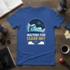 Waiting For Clear Sky t-shirt design with a silhouette of a person looking through a telescope at a starry night