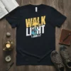 Christian t-shirt with "Walk in the Light 1 John 1:7" text, featuring a sunburst and two people walking on a