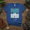 Walking Free quote on a blue t-shirt with an open book, running figure, keys, and birds graphic