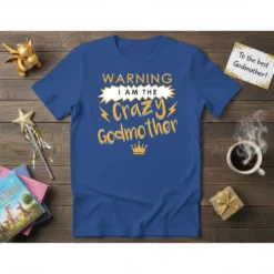 Blue t-shirt with "WARNING I AM THE Crazy Godmother" text in yellow and white, featuring lightning bolts and a crown
