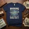 Navy blue t-shirt with "WARNING MAY START TALKING ABOUT WORLD WAR 2" text and a vintage airplane graphic